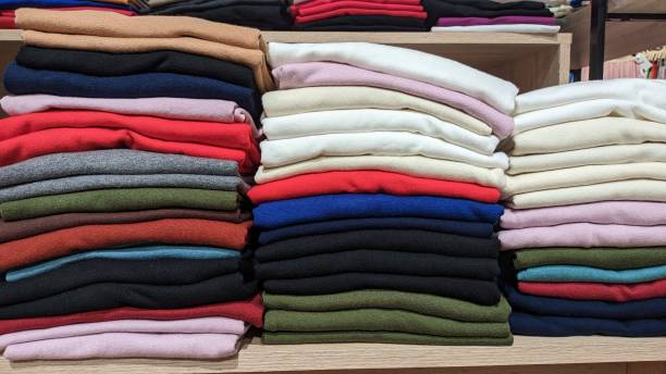 istock Different color fabrics stacked one on top of the other in a stack selling textiles in a store 1514189413