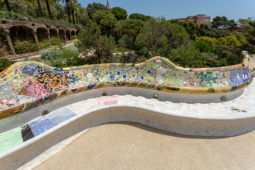 Barcelona, Spain - June 14, 2022:  Summer tourist crowd gathers in Park Guell designed by artist and architect Antoni Gaudi in Barcelona Catalonia Spain