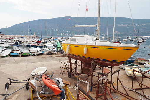 Herceg Novi, Montenegro, 08.09.22 Parking of yachts, boats and boats. Seaside city. Yacht storage in the Bay of Kotor. Adriatic coast, Mediterranean. Downtime of the vessel and repair of sailboats.