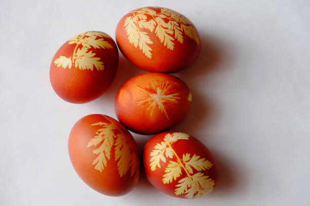 istock Painted Easter eggs on a white background. Floral pattern on a red eggshell. Festive food. 1514243428