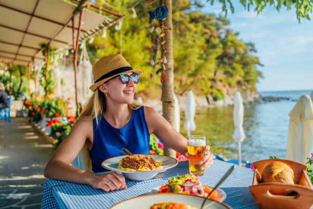 istock Woman eating pasta in a seaside restaurant 1514244489