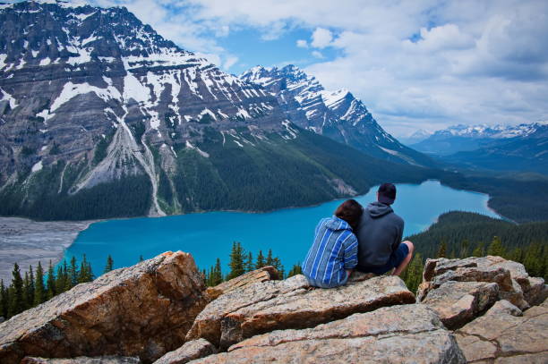istock Couple sitting above Peyto lake 1514246080
