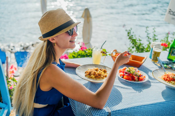 Woman having lunch in a seaside restaurant