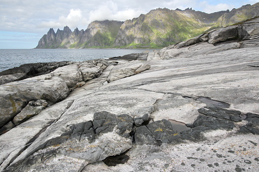 Ersfjord.Norway.Northern Norway.Senja Island. Devils Teeth is this mountaingroup called on Senja island. The mountains and cliffs at the North Polar Sea are rough and expressive.