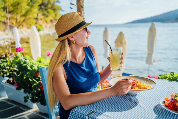 istock Woman having lunch in a seaside restaurant 1514248715