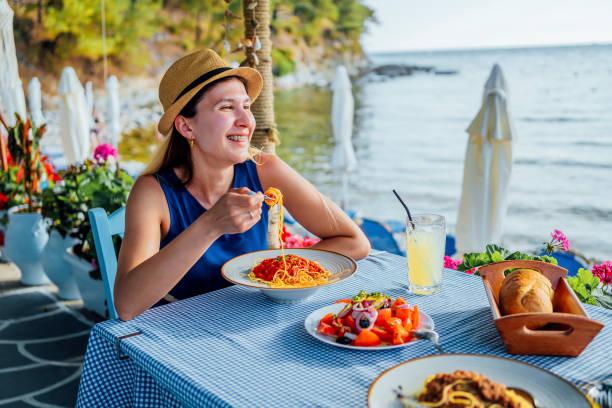 istock Woman having lunch in a seaside restaurant 1514249784