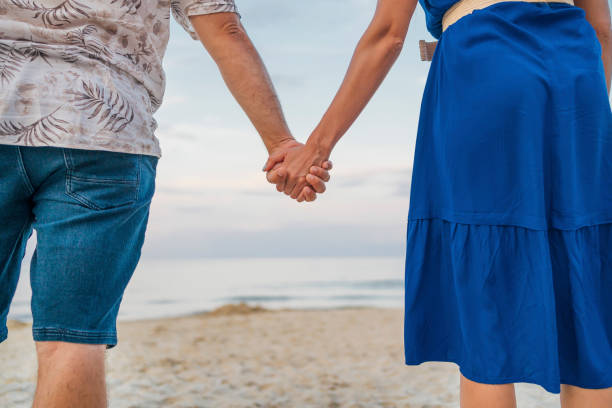 istock Couple holding hands on the beach 1514255257