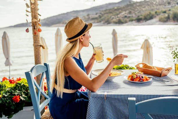 istock Woman having lunch in a seaside restaurant 1514261148