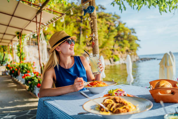 istock Woman having lunch in a seaside restaurant 1514262211