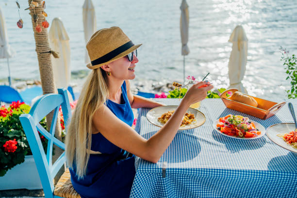 istock Woman eating pasta in a seaside restaurant 1514262724