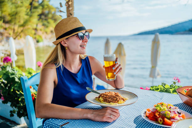 istock Woman eating pasta in a seaside restaurant 1514263253