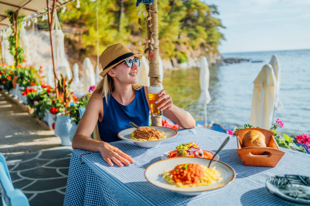 istock Woman eating pasta in a seaside restaurant 1514263776