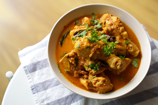 Indian curry chicken served in white bowl