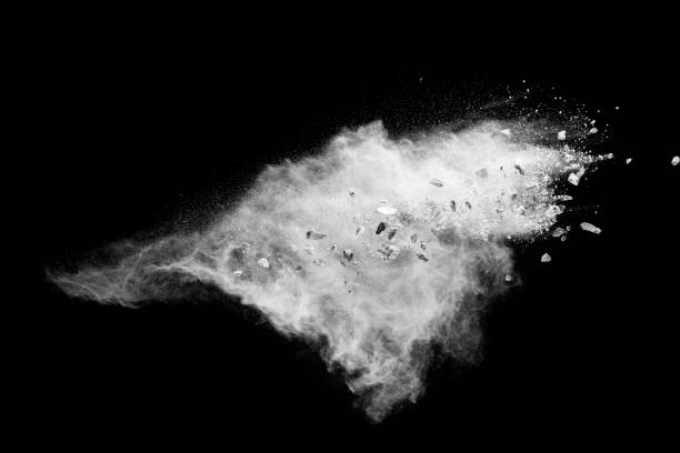 istock White powder with small stones on black background. Small granite rock stone fly on dust against dark background. 1514276033