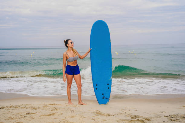 istock Female surfer on the beach 1514295602