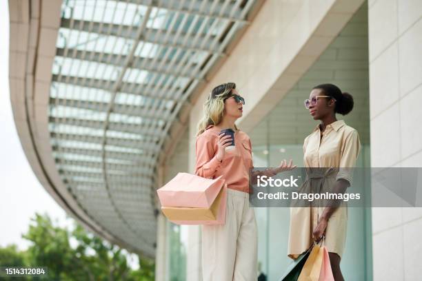 Stylish Women Standing At Mall Entrance Stock Photo - Download Image Now - 20-24 Years, 30-34 Years, Adult