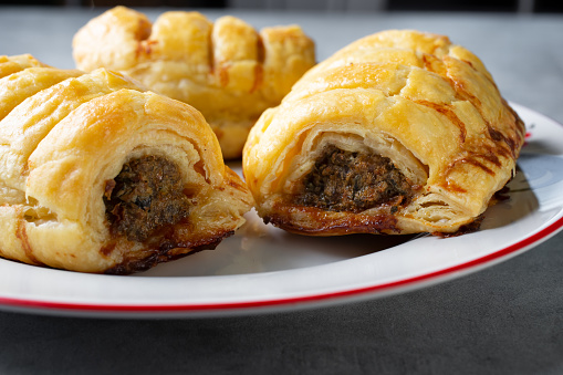 A closeup view of a plate of Dutch sausage rolls known as saucijzenbroodjes.