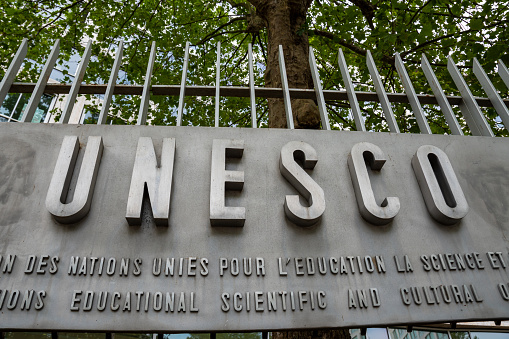 Paris, France - July 4, 2023: Sign outside the headquarters of UNESCO, an international institution of the United Nations specialized in education, science and culture