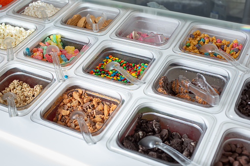 A view of a variety of toppings, seen at a local frozen yogurt restaurant.