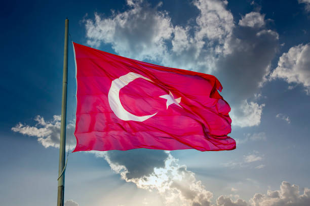 istock Turkey flag waving in blue cloud sky 1514375261