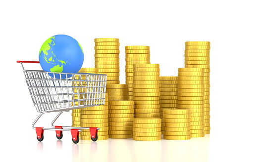 Globe World Map in The Shopping Cart With Coins On White