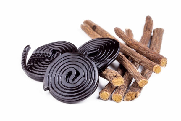 istock Licorice candy wheels and Licorice root on the white background 1514391454