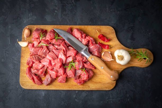 istock Heap of raw chopped beef isolated on cutting board 1514397385