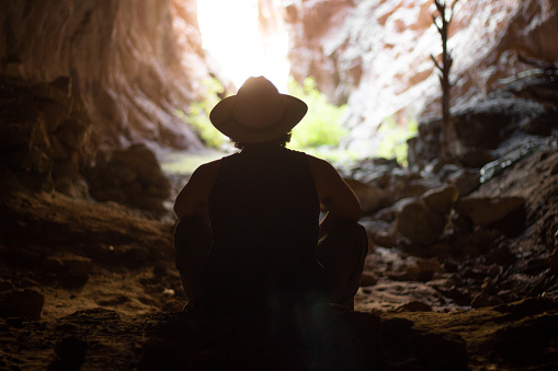 Explorer relaxing inside a cave