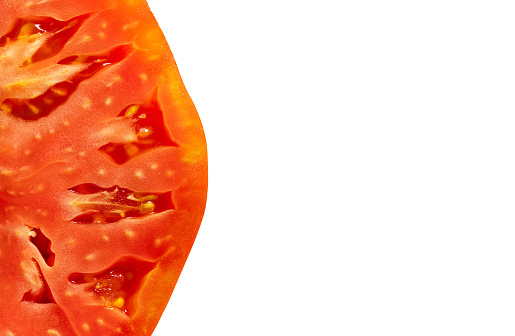 Fresh tomato half cut macro closeup texture detail mediterranean food with white copyspace