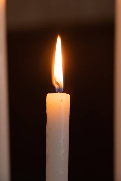 istock Single burning candle in the foreground 1514417687