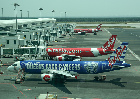 Kuala Lumpur, Malaysia - Apr 13, 2016. AirAsia airplanes docking at Kuala Lumpur Airport (KLIA). KLIA is the world 23rd-busiest airport by total passenger traffic.