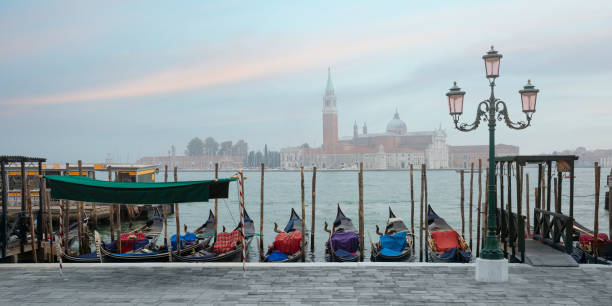 Gondolas at twilight in Venice lagoon, Italia