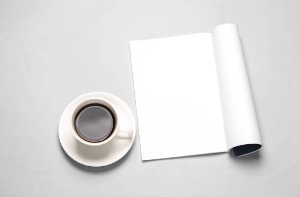 istock White blank magazine page mockup and coffee cup on gray background 1514496727