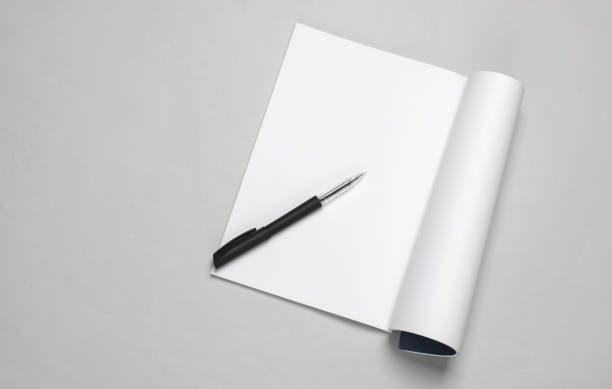 istock White blank magazine page mockup with pen on gray background 1514497235