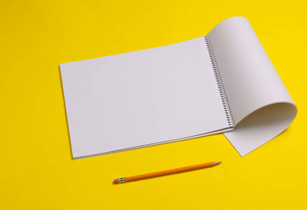istock White blank sketchbook with pencil on yellow background 1514497242