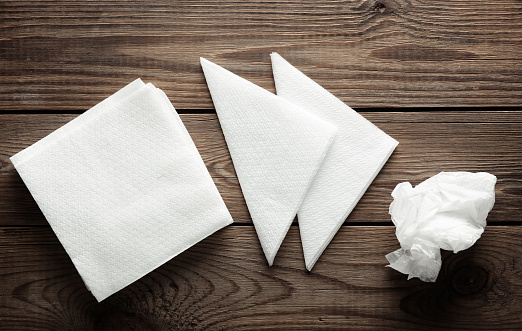 White napkins on a wooden table. Top view