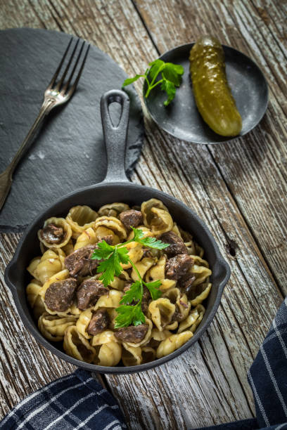 istock Italian pasta shells with beef sauce in cast iron pan. 1514511791
