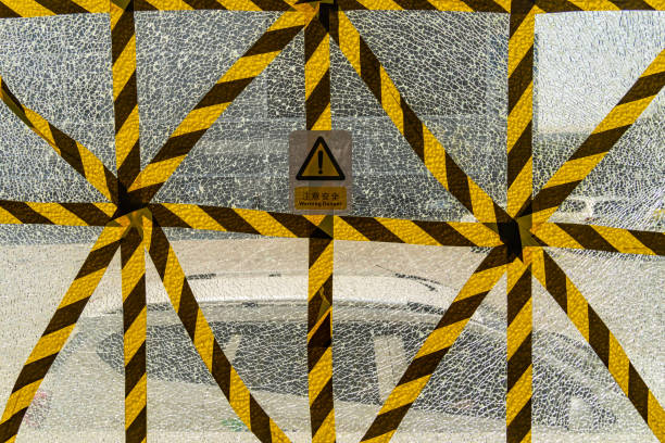 Yellow tape across broken glass window