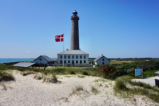 View of the lighthouse in Skagen on a sunny summer day. The northernmost Danish lighthouse. Brick lighthouse.