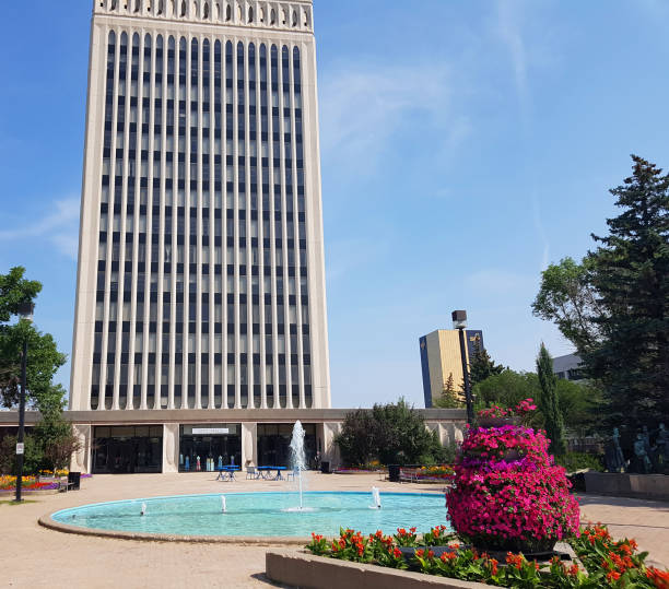 Regina,Saskatchewan, Canada- June 30,2023: Regina City Hall. Downtown. Built in 1976. Water feature with walkway in front of building. Gardens throughout. Plaza.