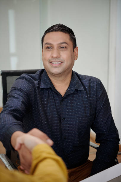 istock Smiling Entrepreneur Greeting Colleague 1514565731