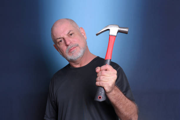 adult man using holding hammer service equipment tool for mechanic locksmith nailing material objectsSenior Life