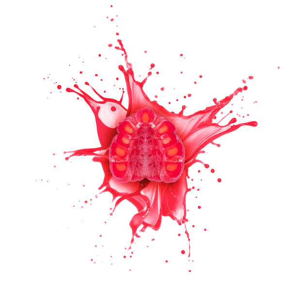 istock Half of a cut raspberry with a splashes of juice isolated on a white background 1514594796