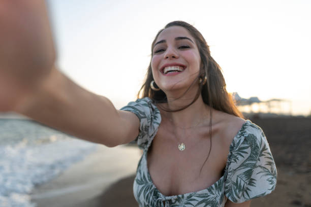 istock Woman taking selfie on the beach. 1514598404
