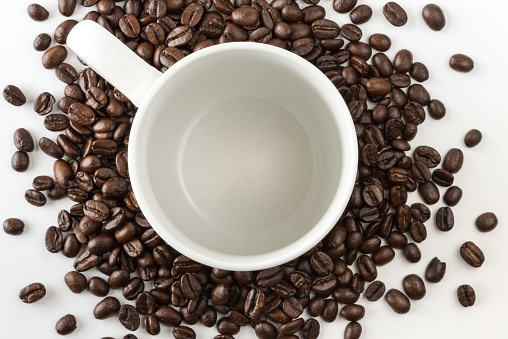 Coffee Cup Surrounded by Coffee Beans