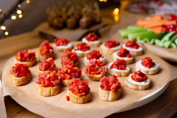 istock Appetizer crostini with tomatoes, diced red bell peppers and cream cheese spread. 1514630896