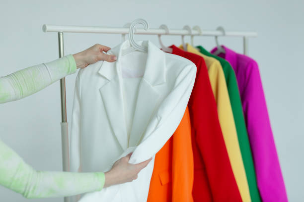 istock A woman's hands chooses clothes on a hanger on a white background. 1514635767