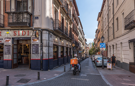 Madrid, Spain - June 22, 2023: Hot afternoon in the lively life of the Barrio de Malasaña in Madrid. Malasaña is a vibrant neighborhood and center of the 'hipster' phenomenon, full of lively bars and nightclubs brimming with young people.