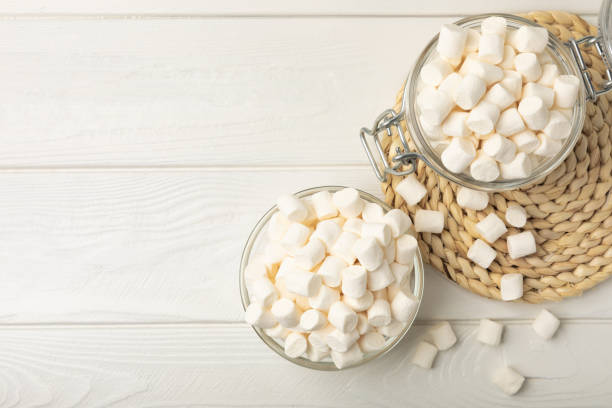 istock Loose white marshmallows on white texture wood.Sweets and snacks for a snack.Chewy candy close-up.Copy space.Place for text. 1514684074
