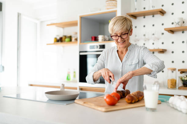 istock Woman cutting vegetables on kitchen board 1514691951